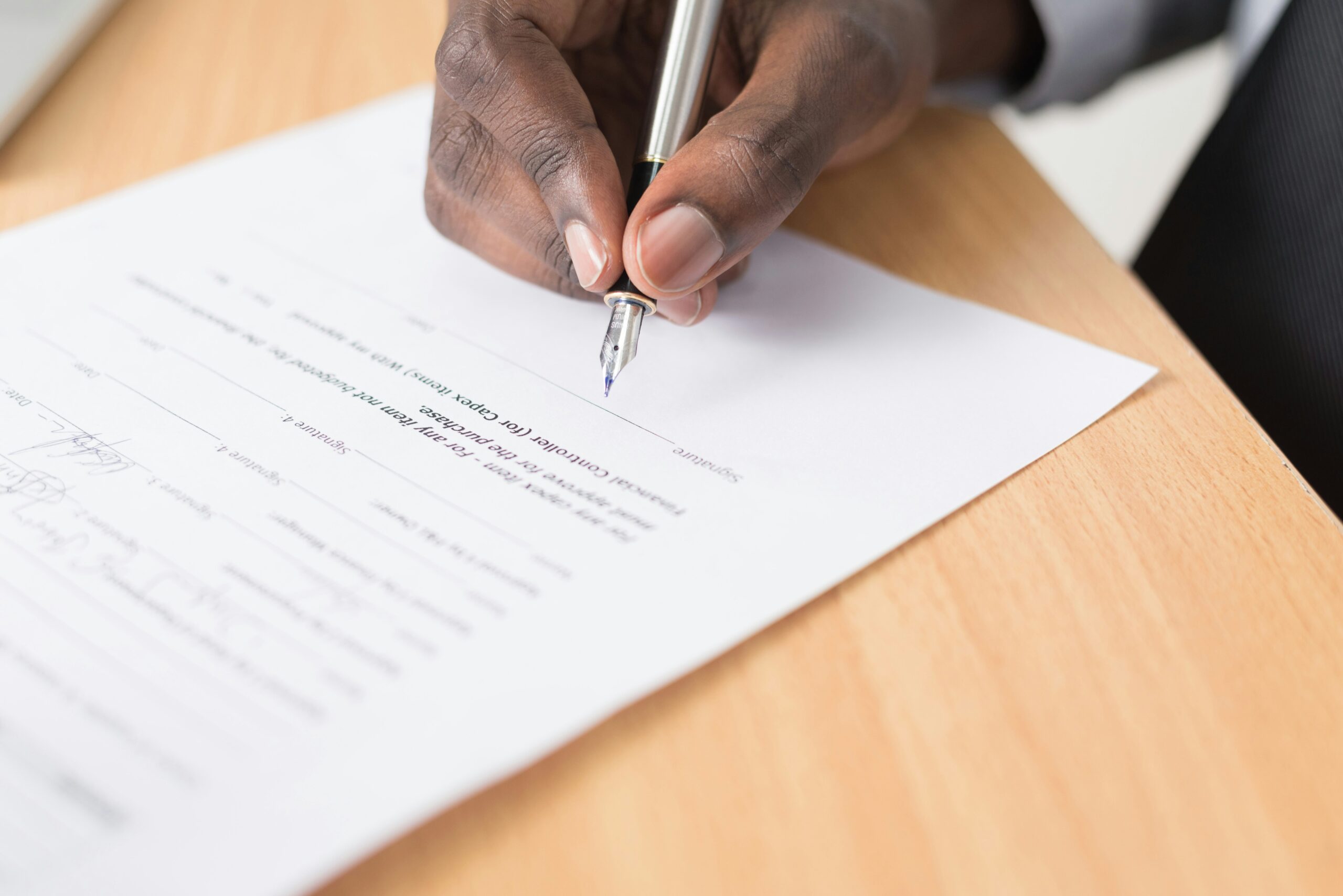 Signing a contract after negotiating with suppliers